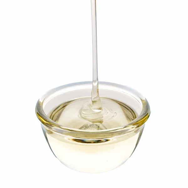 Golden liquid cane sugar flowing from above with thick texture.