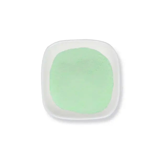 Light green pandan jelly powder in a white dish, used to make aromatic Southeast Asian-style jelly.