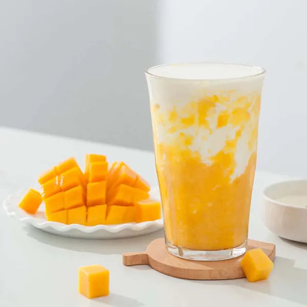 Mango cream drink with layered fruit texture – rich color and tropical appeal.