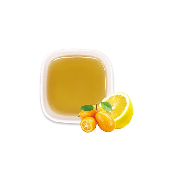 Kumquat lemon syrup with fruits, showcasing golden hue and tangy aroma – perfect for teas and fizzy drinks.
