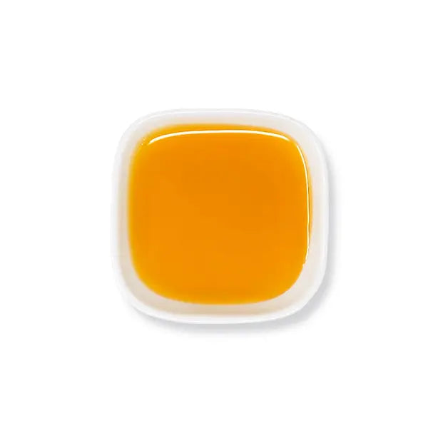 Top view of pineapple syrup with bright golden color and smooth texture.