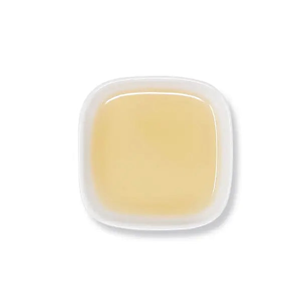 Top view of lychee syrup with smooth, creamy beige hue.
