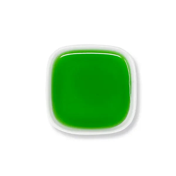 Top view of green apple syrup with bright color and smooth, syrupy consistency.