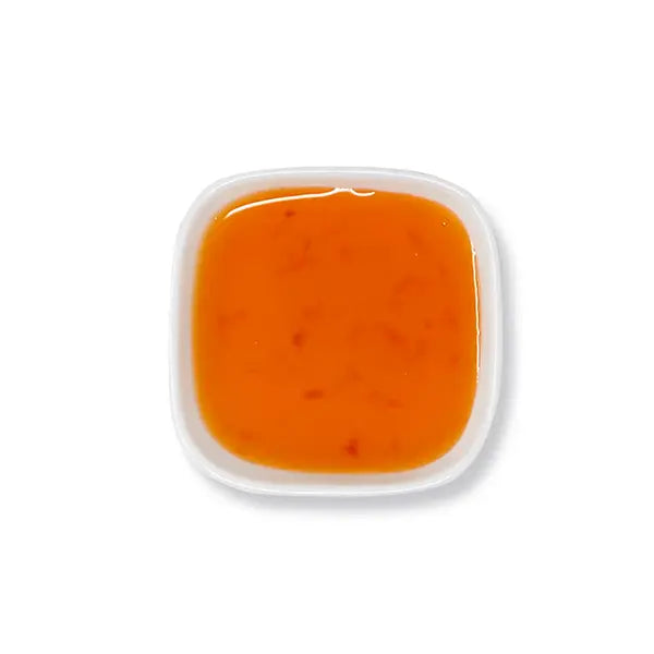 Top view of peach syrup showing smooth honey-orange tone and clarity.
