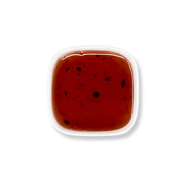 Top view of blueberry syrup – visible pulp and rich purple-red tone.