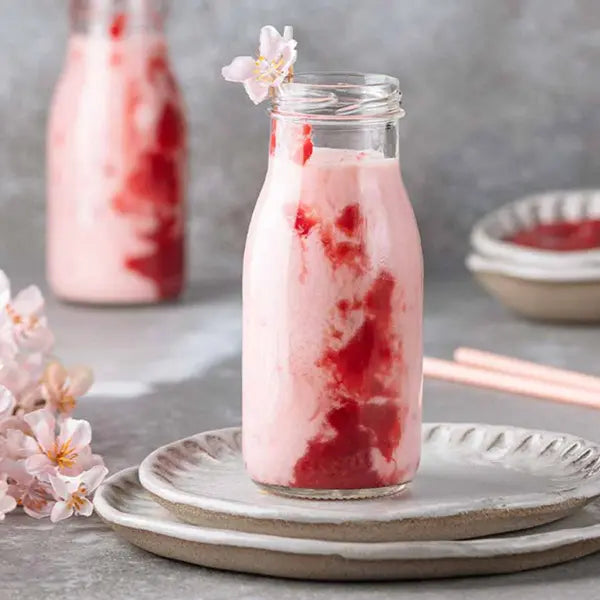 Dreamy sakura yogurt drink with floral topping – perfect for a springtime vibe.