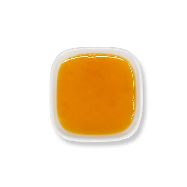 Top view of orange syrup – vivid orange tone and smooth consistency.