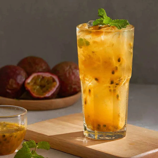 Golden passion fruit drink with pulp and mint – tangy, refreshing, and visually bright.