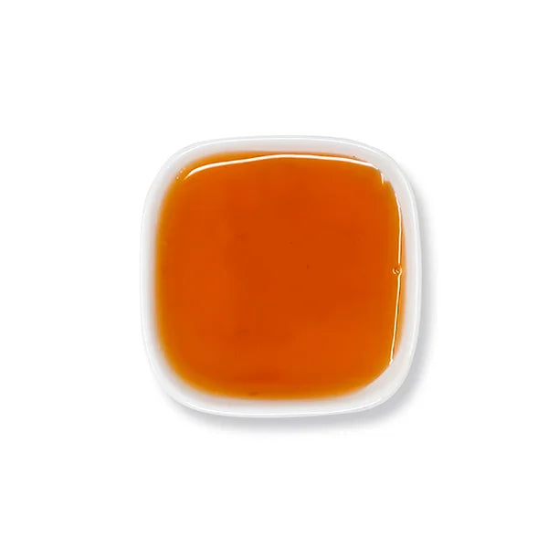 Top view of passion fruit syrup – smooth texture and bright amber color.