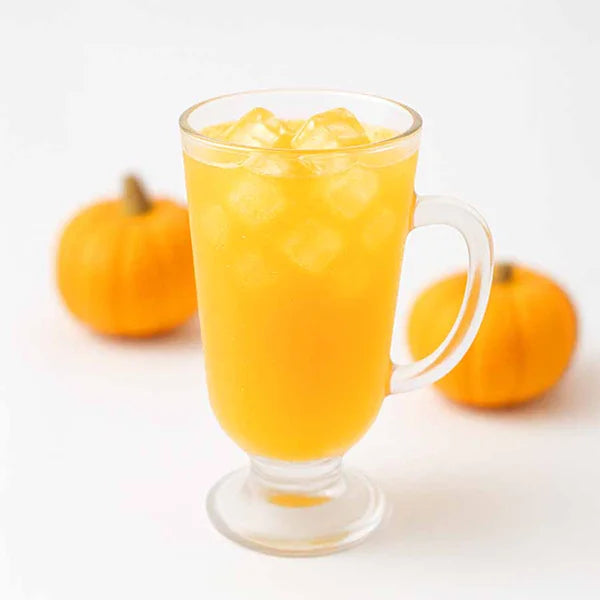 Iced pumpkin drink with milky base – bright color and autumn vibe.