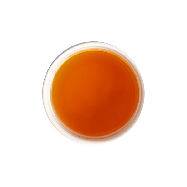 Brewed Earl Grey tea with bright ruby-red liquor and citrus aroma.