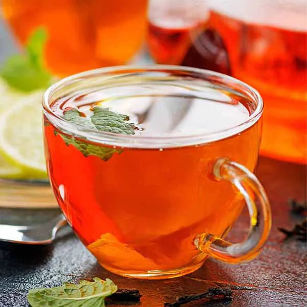 Earl Grey tea drink with lemon and mint, bright amber color and citrus flavor.