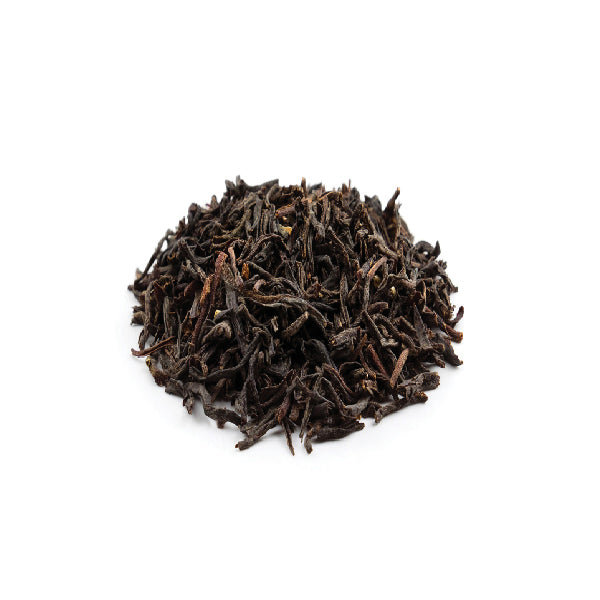 Dry Tie Guan Yin tea leaves – tightly rolled and dark brown.