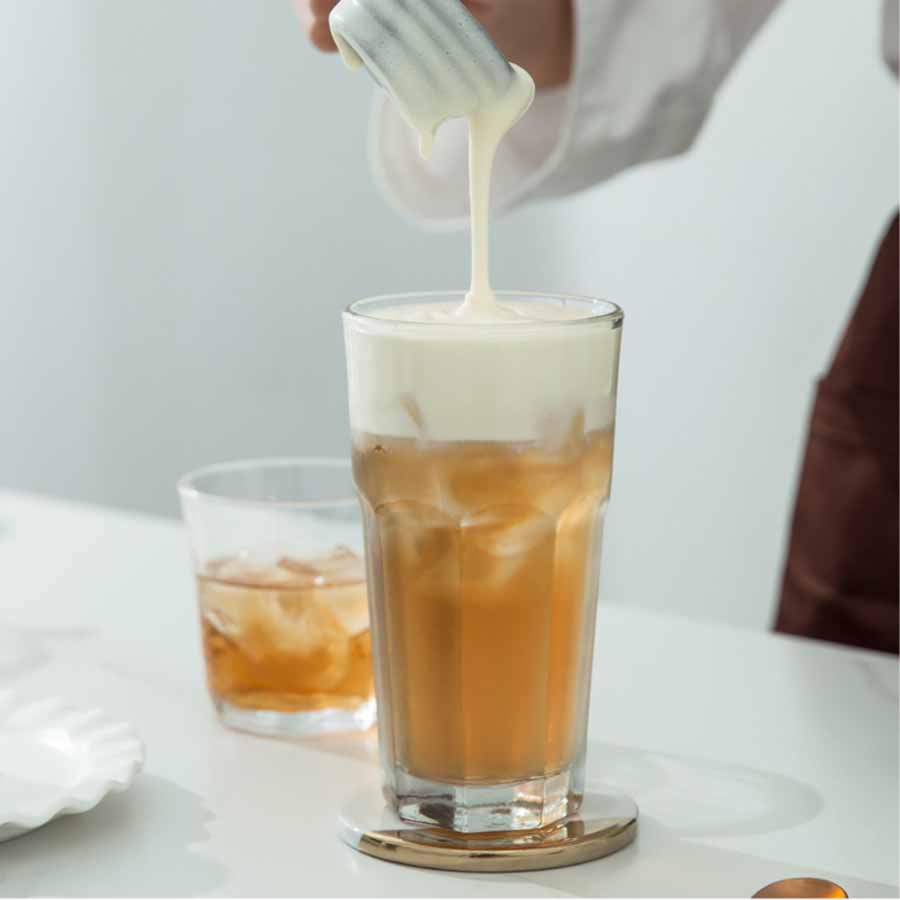 Tie Guan Yin milk tea in preparation – strong oolong tea with milk.