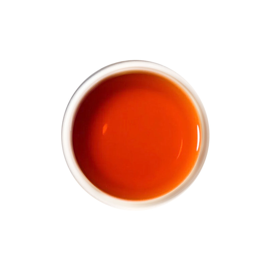 Dark reddish-brown brewed pu erh tea with rich, earthy aroma.
